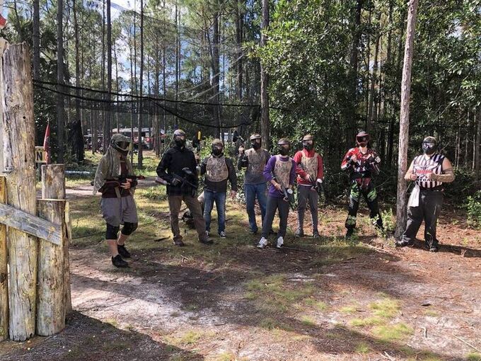 Paintball players advancing across the XPlex field