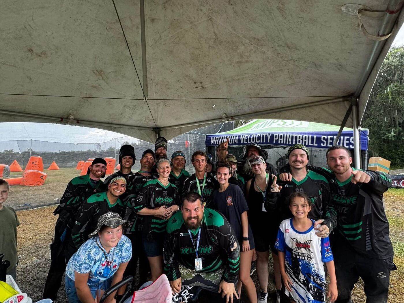 XPlex team and family celebrating together under a tent